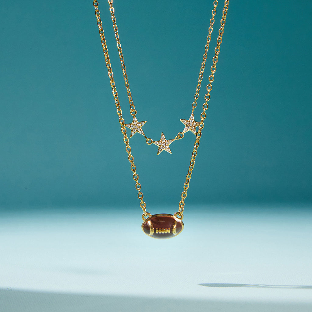 double-chain necklace with brown football and three clear-stone stars