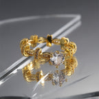 gold plated brass linked ring on reflective display