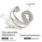 Open ring with decorated loop and polished spiral ends
