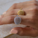 Two mesh dome rings worn on a hand