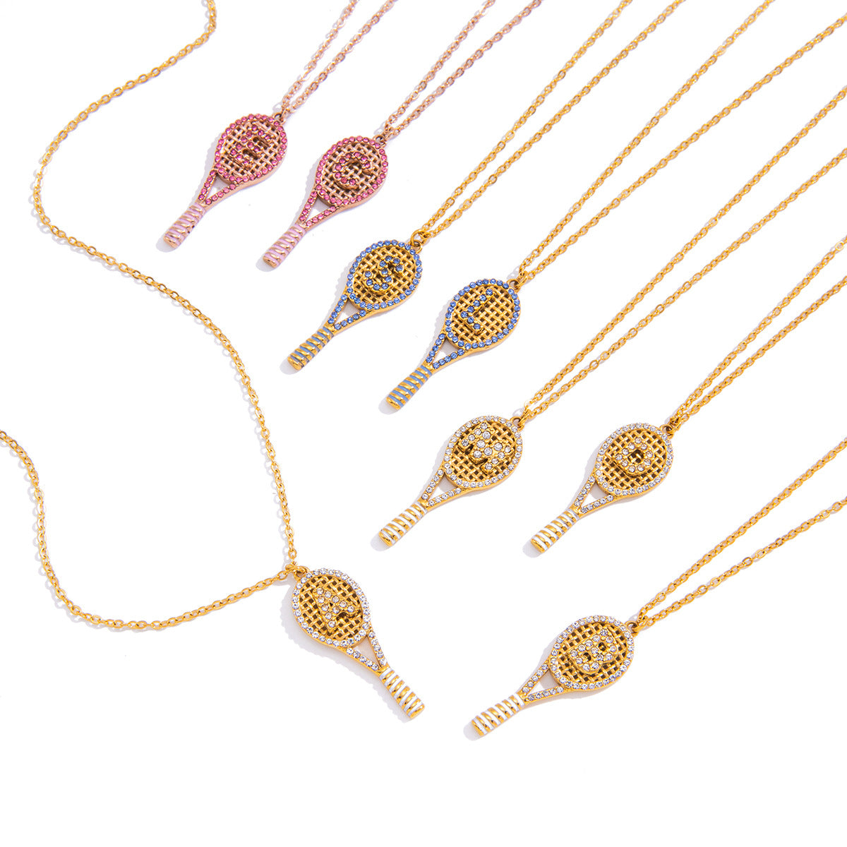 Gold, pink and blue accent racket pendants on white