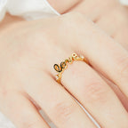 angled worn view of the polished LOVE script adjustable ring