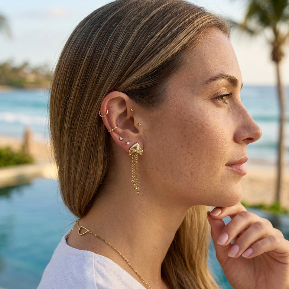 Long chain fringe earrings shown on a model