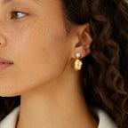 Polished dome stud worn with a dark top