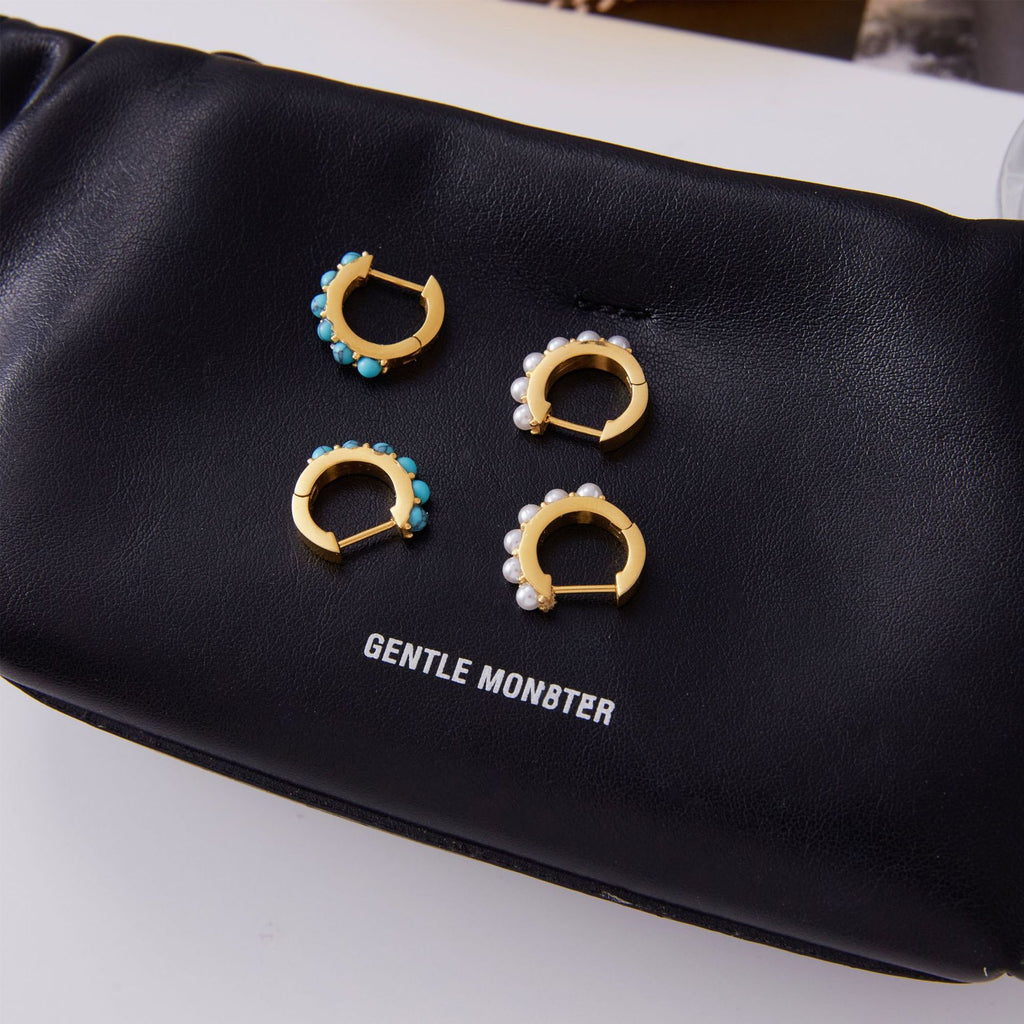 Blue bead and imitation pearl huggie earrings on display card