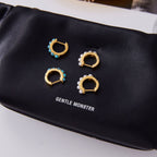 Blue bead and imitation pearl huggie earrings on display card