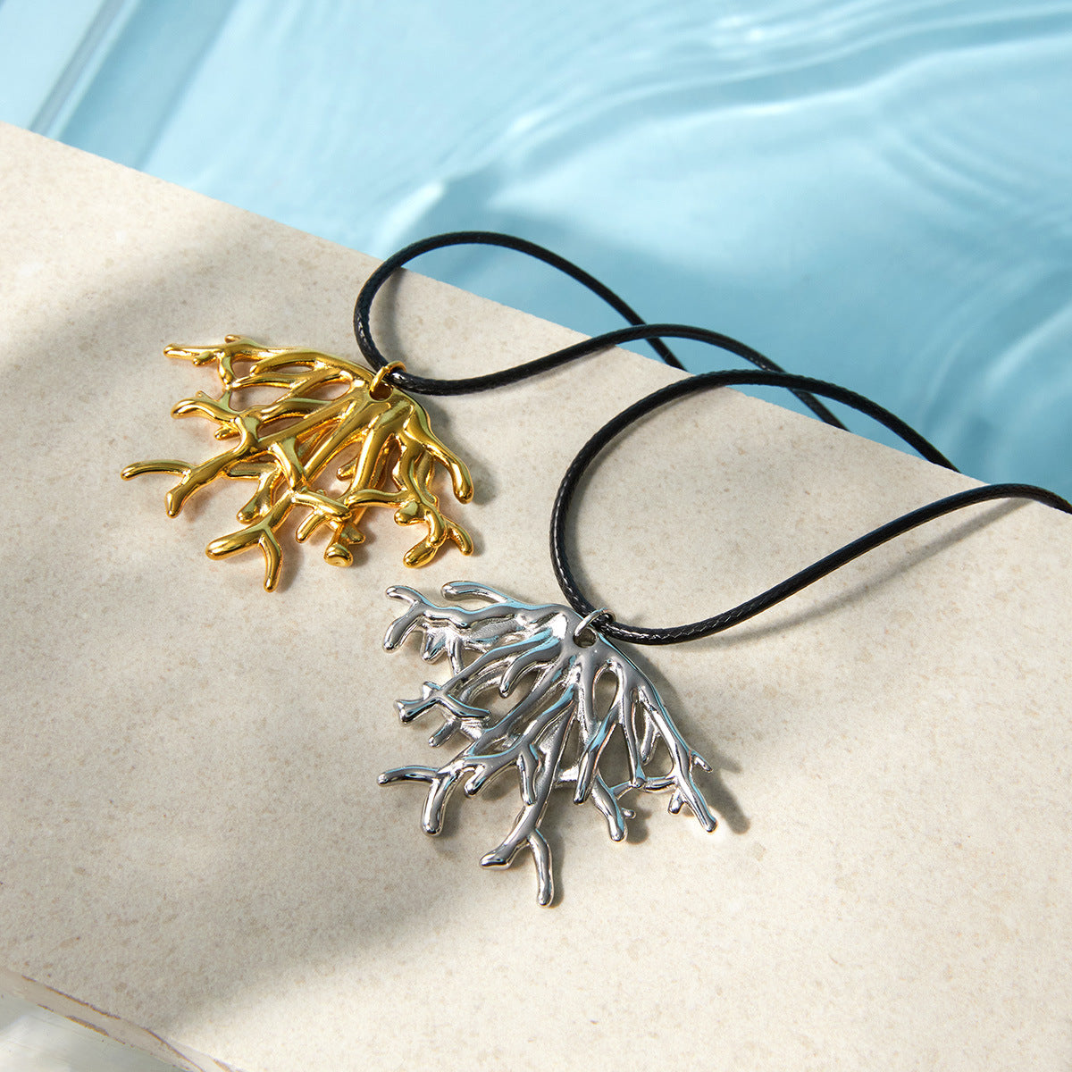 Branching pendants on black cords beside a pool