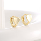 angled pair of compact hoops with smooth solid heart fronts
