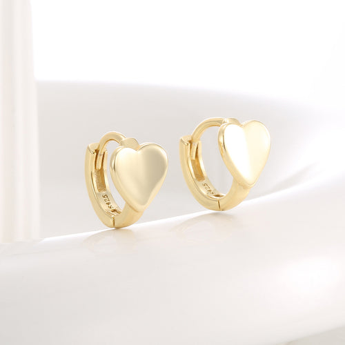 angled pair of compact hoops with smooth solid heart fronts