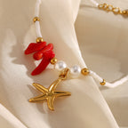 close-up of textured gold plated starfish charm and red chip-bead cluster