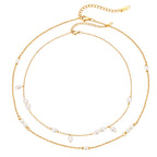Station and cluster necklaces on white