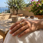 Gold-tone pear-stone ring worn outdoors