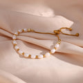 gold plated freshwater pearl slider bracelet styled on blush fabric