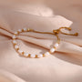 gold plated freshwater pearl slider bracelet styled on blush fabric