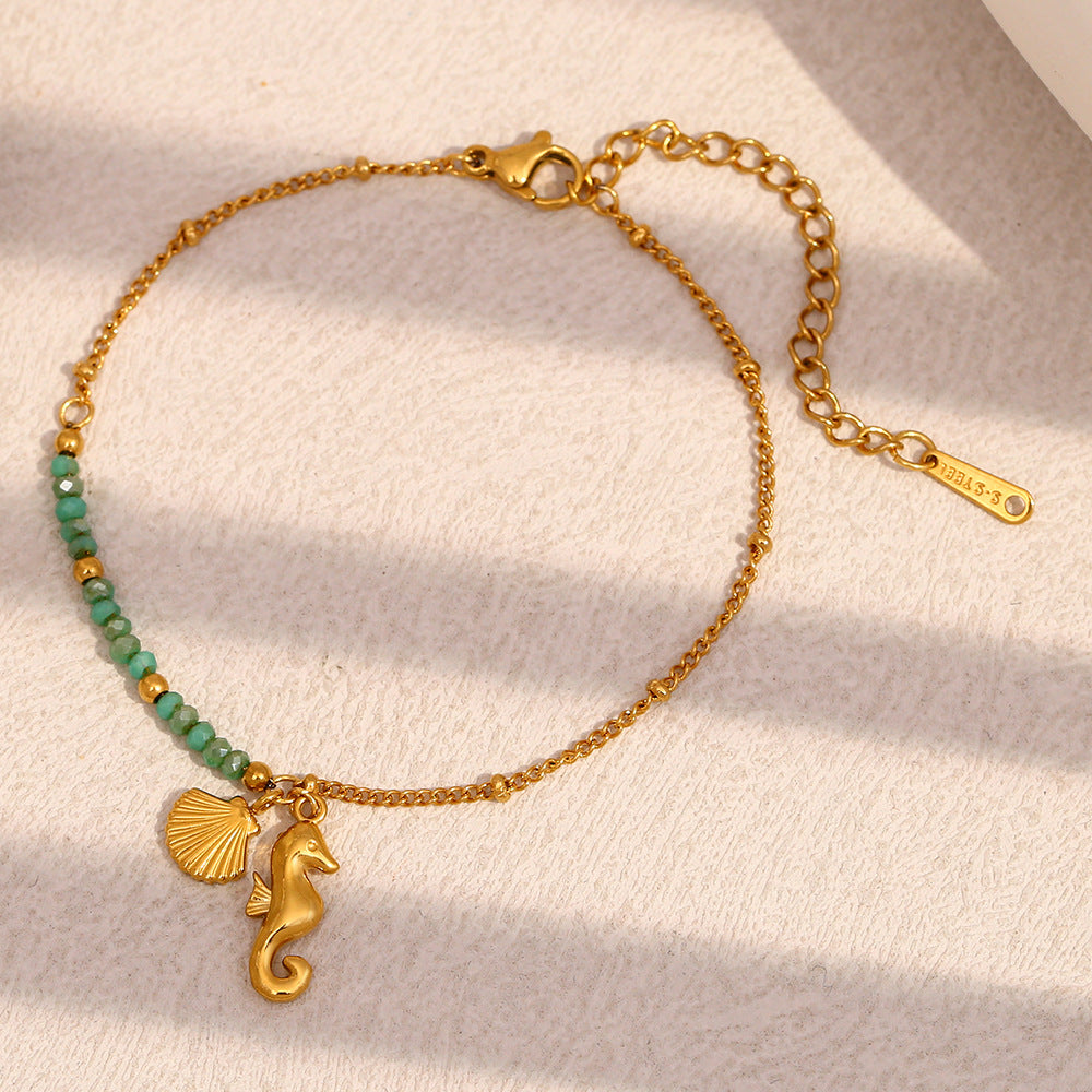 Gold Plated Stainless Steel Green Bead Seahorse and Shell Bracelet — worn view