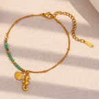 Gold Plated Stainless Steel Green Bead Seahorse and Shell Bracelet — worn view