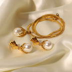 Necklace and matching white glass bead drops arranged on satin