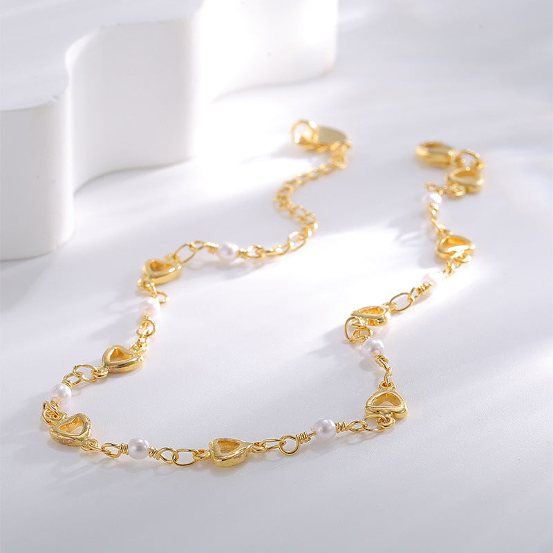 gold plated beaded anklet with repeating outline heart links