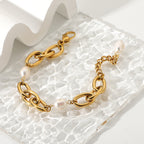 gold plated oval-link pearl bracelet on textured glass