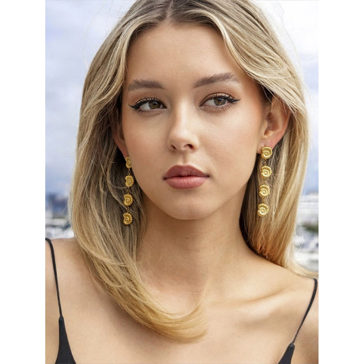 Long shell earrings shown as references beside the necklace collection