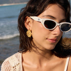 Irregular oval earrings shown on a model