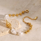 Close-up of sculpted gold detail among white pearl-look beads