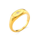 isolated stainless steel oval signet ring with starburst engraving