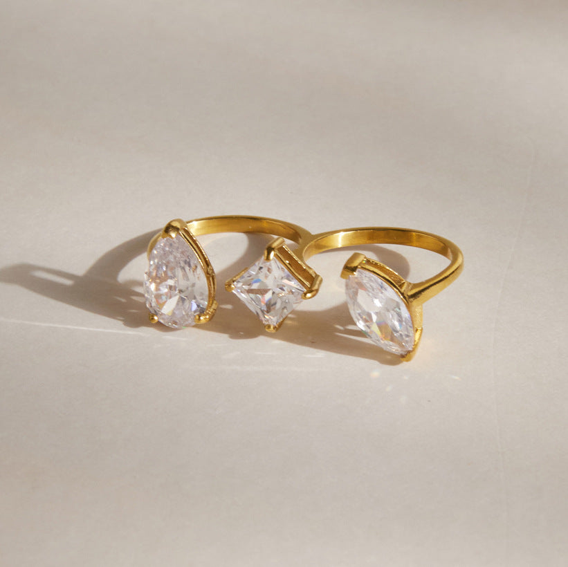 Gold tone double-finger ring with three zirconia shapes