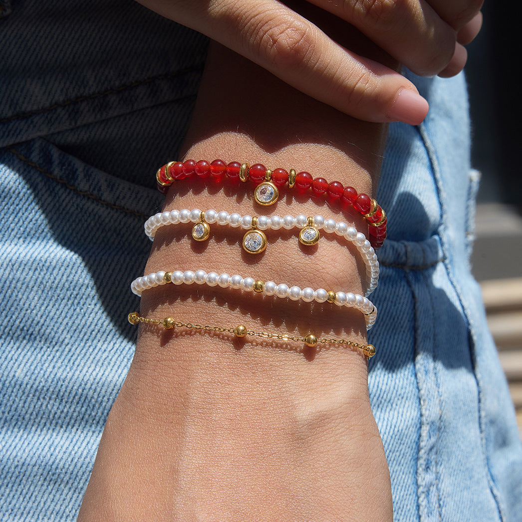 Red and white beaded stainless steel bracelets styled on a wrist
