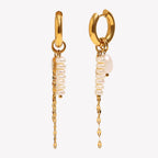 isolated front and side view of asymmetric pearl tassel huggie earrings