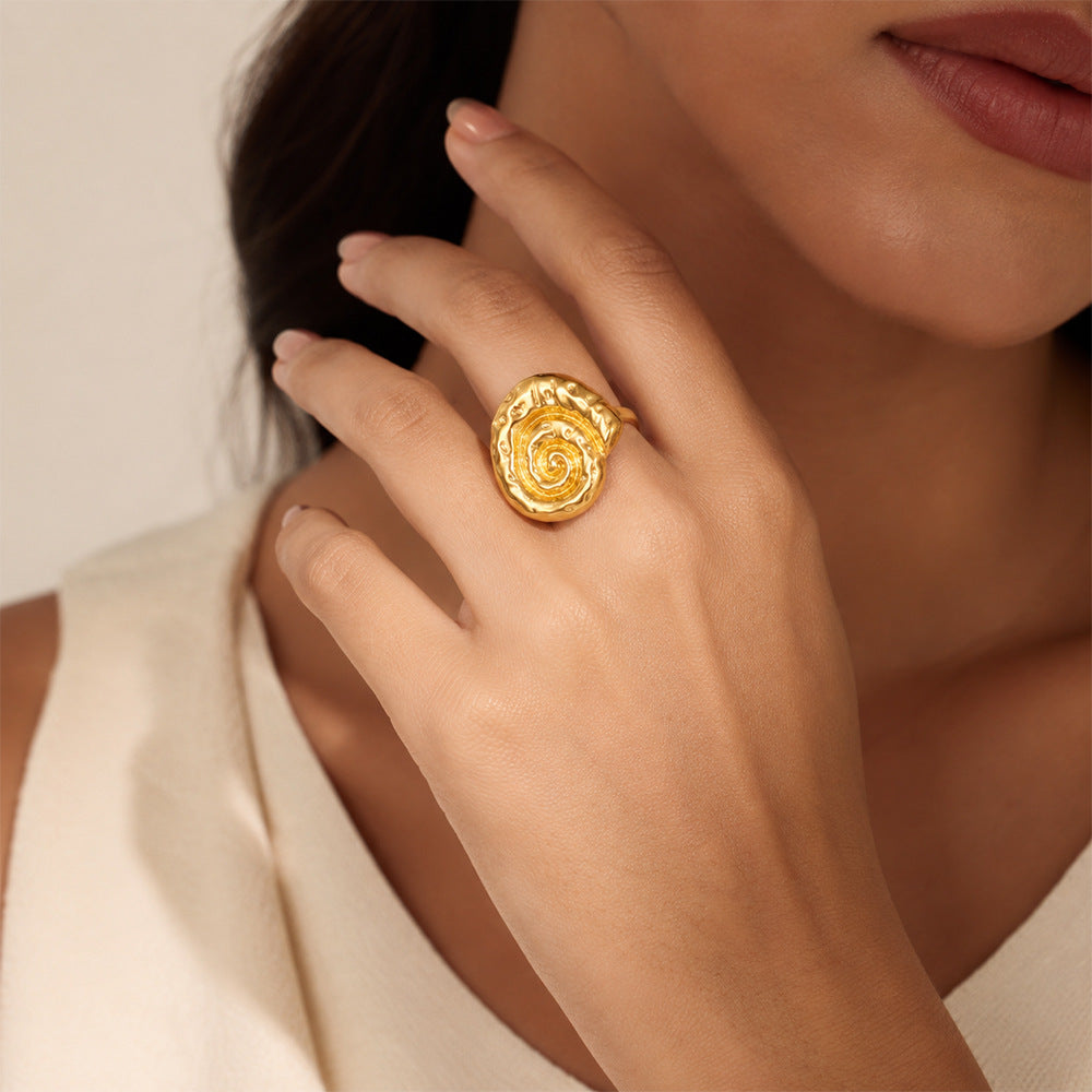 gold-tone spiral shell ring worn on model