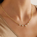 Gold plated clear stone necklace worn at the collarbone