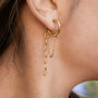gold plated stainless steel hoop earring with asymmetric chain drops worn on ear