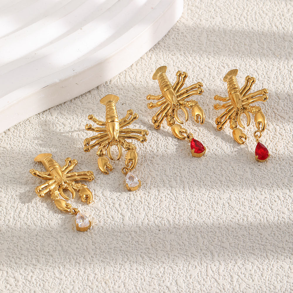 Two lobster earring color options on fabric