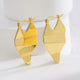 gold plated brass folded geometric drop earrings in studio view