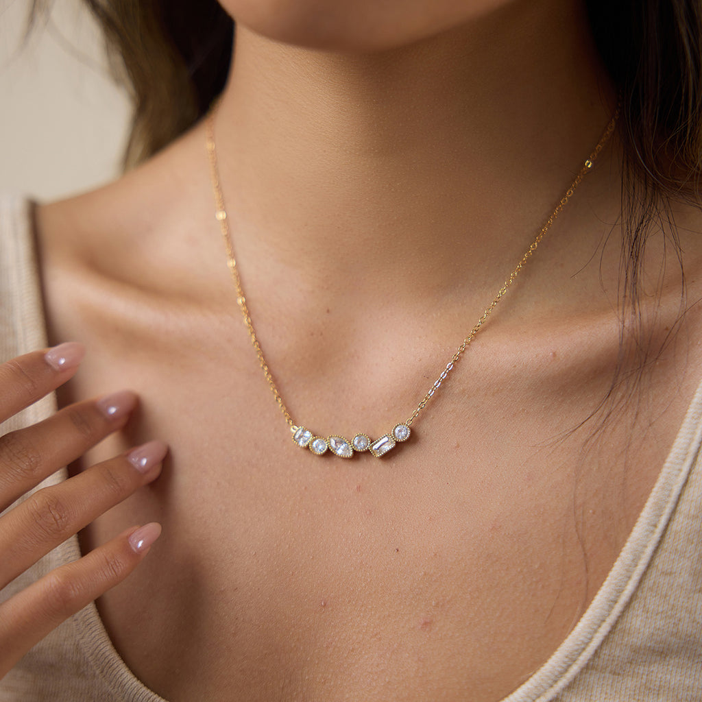 Single clear stone cluster necklace at neckline