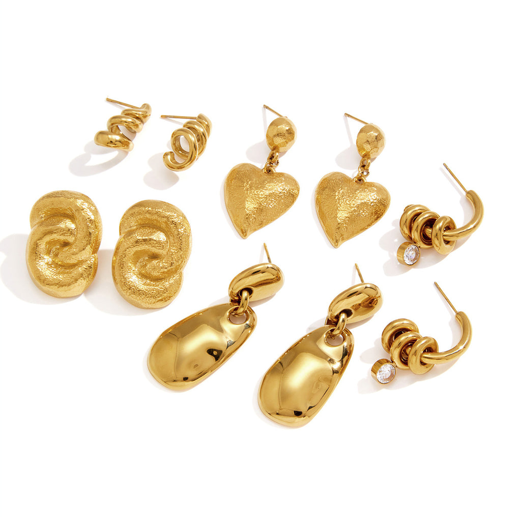 Sculptural stainless steel earring designs arranged on white