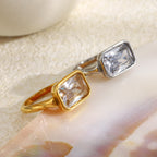 angled view of gold plated and silver-finish rectangular zirconia rings