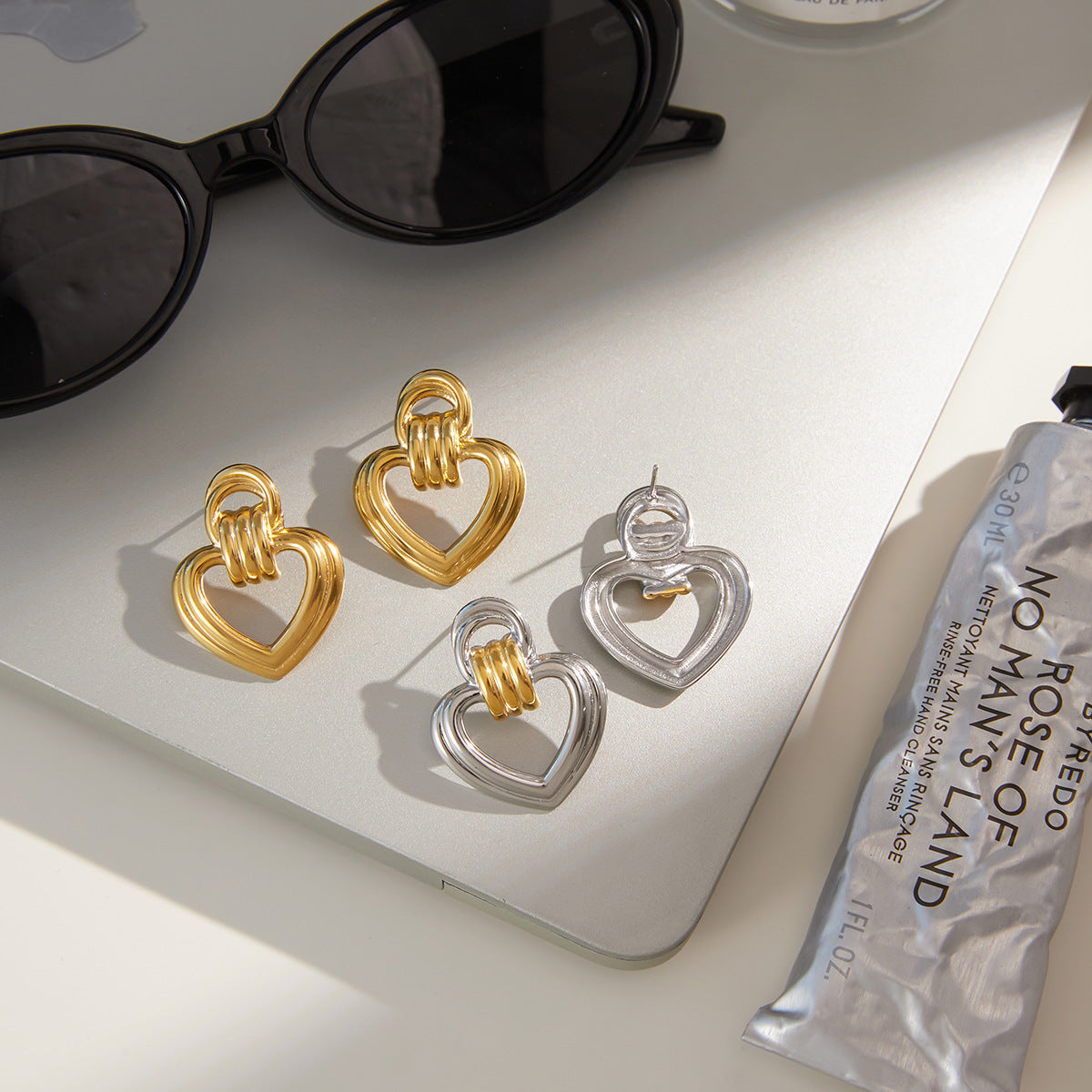 Two-Tone Open Heart Stainless Steel Drop Earrings — front view of the silver outer-heart option