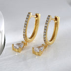 pair of pear clear stone huggie drop earrings standing upright