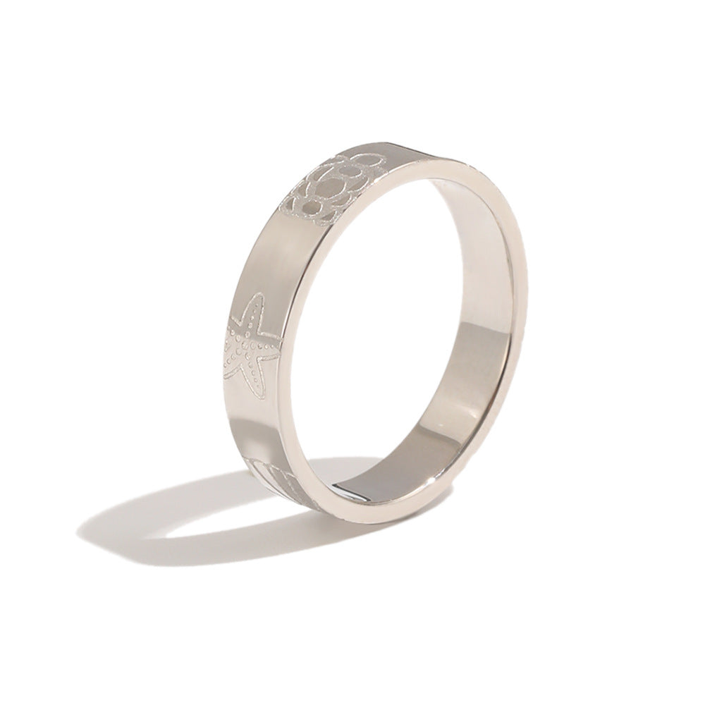 Silver tone band showing fine shell and sea-life outlines