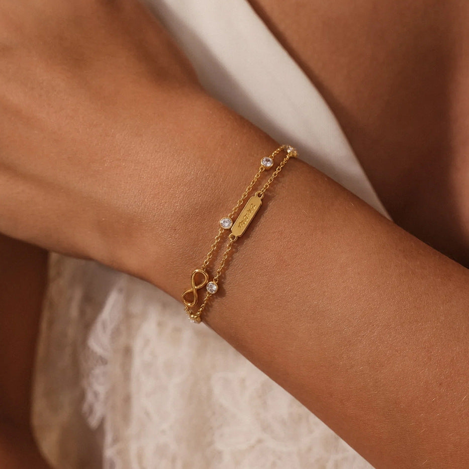 Double-chain infinity and clear stone bracelet worn on wrist