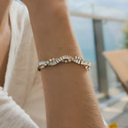 Wavy clear-stone bracelet worn on a wrist
