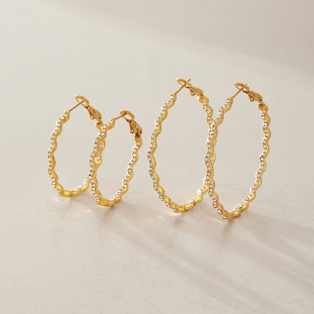 Two sizes of gold tone wavy hoops