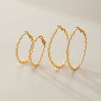 Two sizes of gold tone wavy hoops