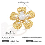 Textured flower ring with white bead center and open band