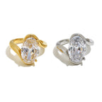 angled pair of stainless steel oval-stone cocktail rings