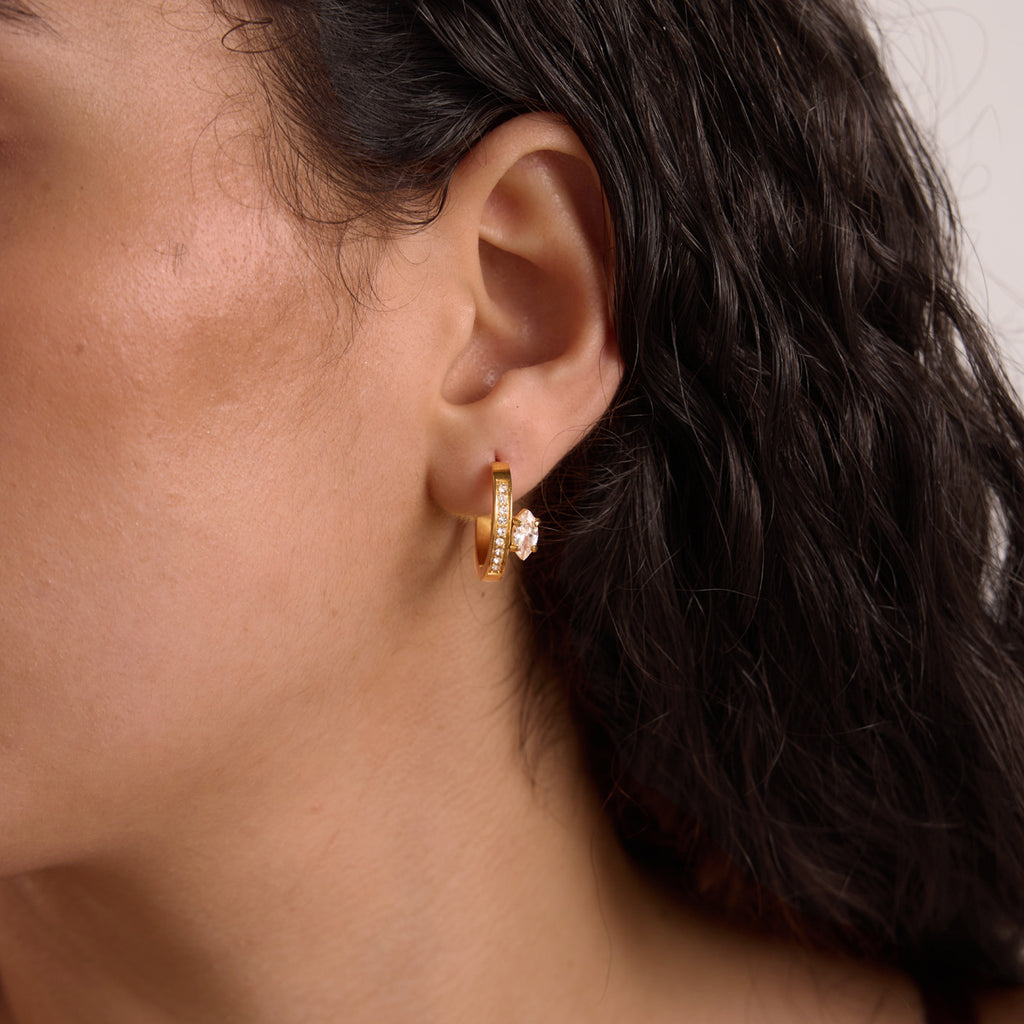 Side-stone hoop worn at the earlobe