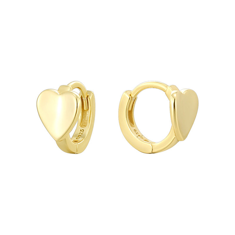 isolated front and profile cutout of gold plated heart huggies