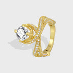 gold plated brass cross-over ring with round clear center stone